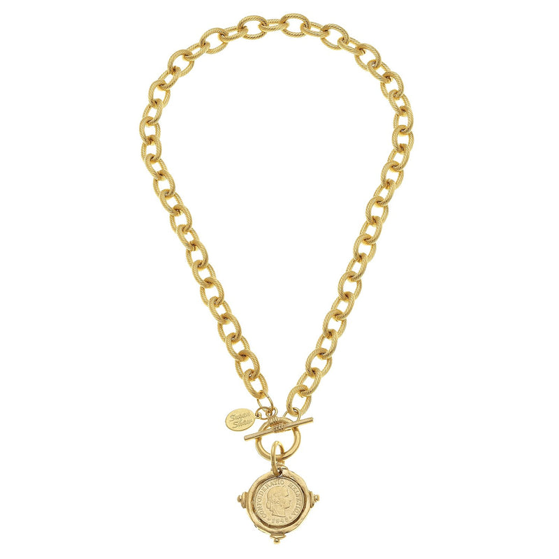 Gold coin toggle necklace with a textured link chain and a round coin pendant.