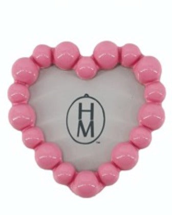 Pink resin heart-shaped photo frame magnet with a beaded border design.