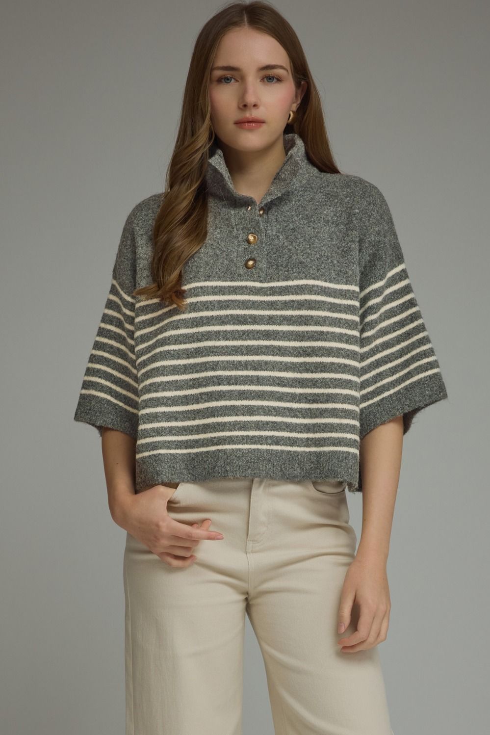 Woman wearing the Charlene Stripe Short Sleeve Knit Top in grey with white horizontal stripes.