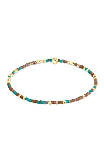 Hand-beaded Hope Unwritten bracelet featuring mixed seed beads in various colors with gold-filled accents on elastic cord.