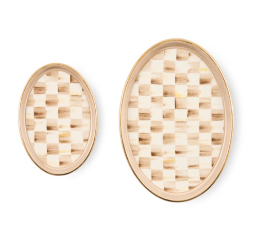Set of two oval ceramic trinket trays with a beige checkered pattern and gold lustre rims.