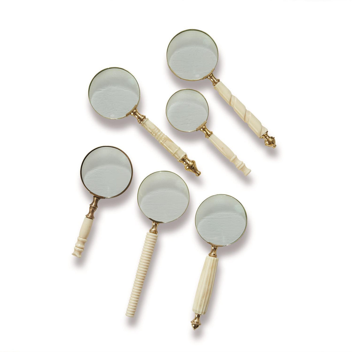 Ivory handle magnifying glass with gold brass detail offering two times optical zoom.