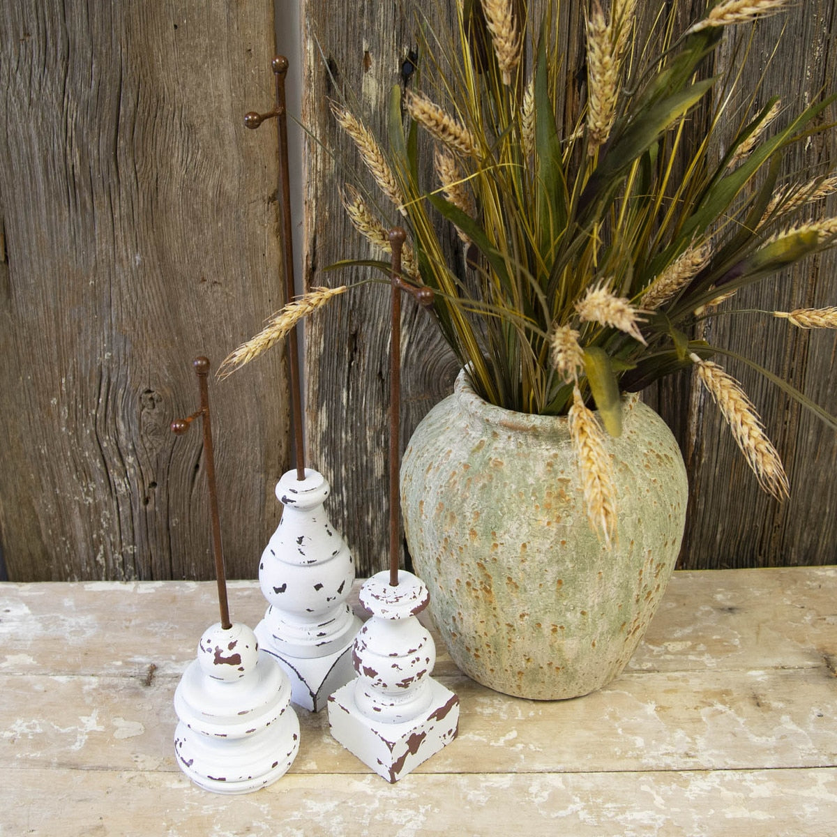 Rust-colored mini gallery display stake with a simple geometric silhouette.
