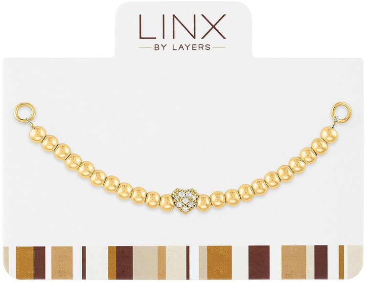 Gold ball bead LINX add-on featuring a central cubic zirconia heart charm on a white display card.