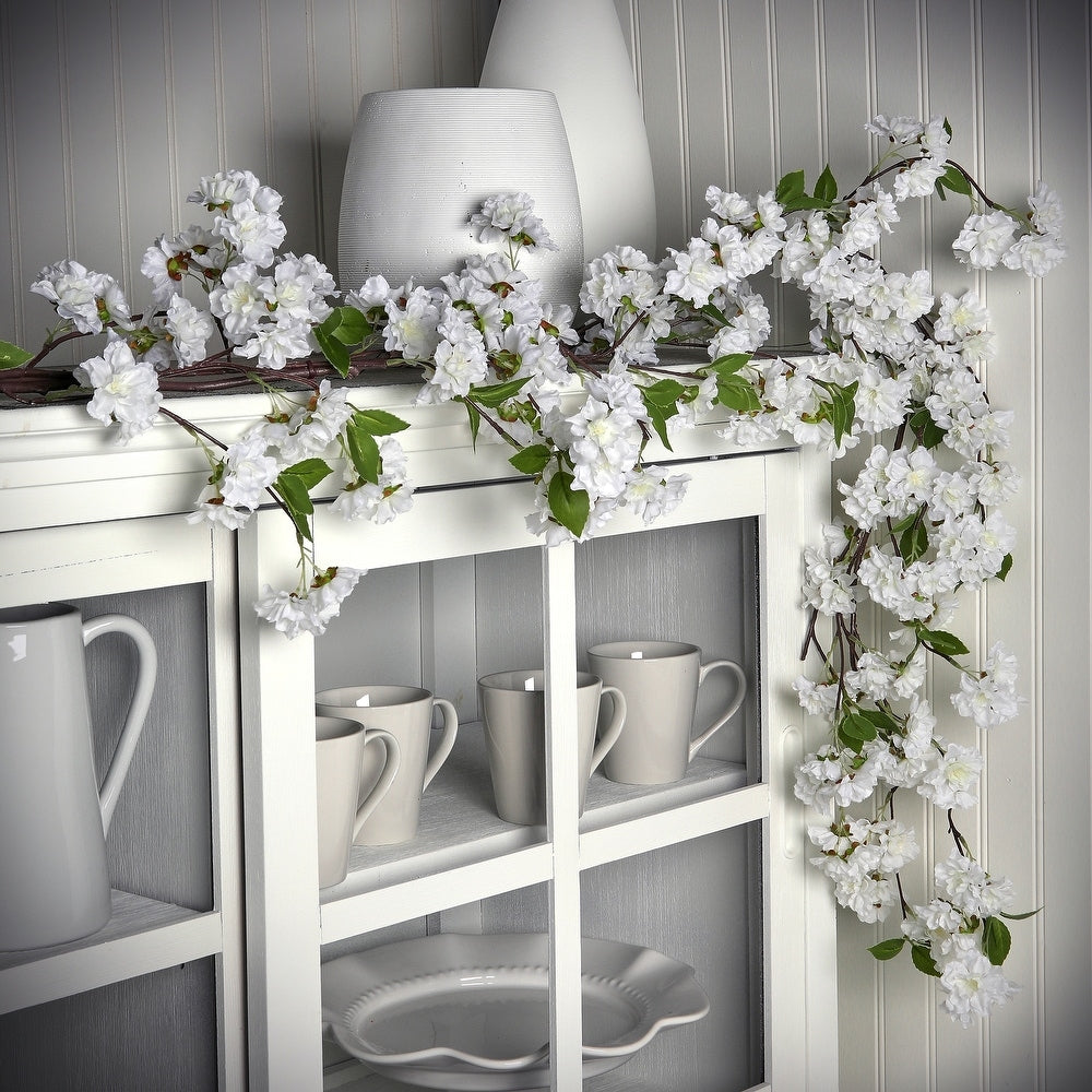 Faux cherry blossom garland in pink polyester with a hanging loop.