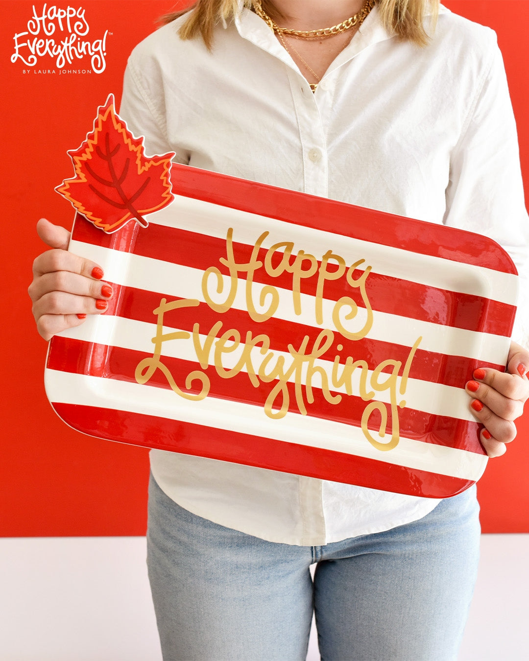 Red ceramic rectangular platter with 'Happy Everything!' text in white script on a red background.