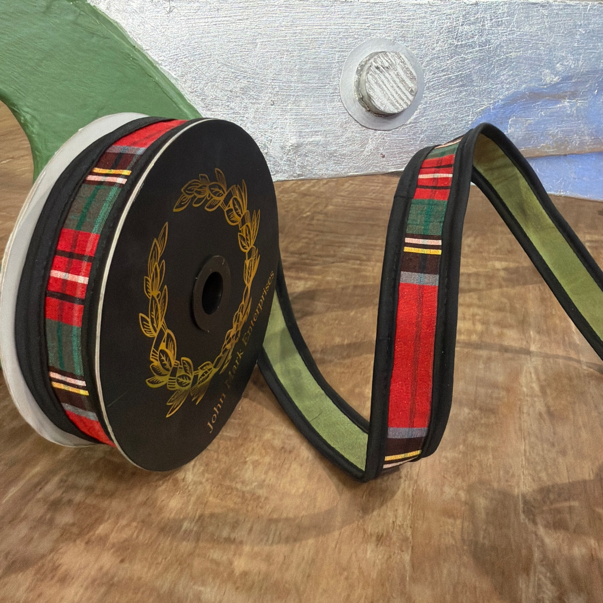 1x10yd Royal Stewart Plaid Fused Dupion Olive Ribbon on a black spool with gold logo.