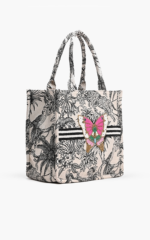 Forbidden Tote in black and white jungle jacquard with a pink beaded butterfly embellishment.