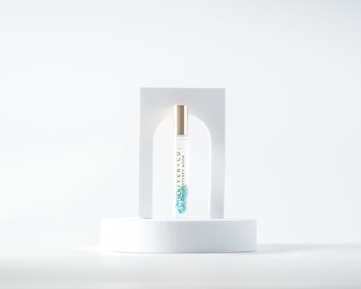 Oliver + Co. Monterey Moon Bougie Stick perfume oil with blue crystals in a glass roll-on bottle.