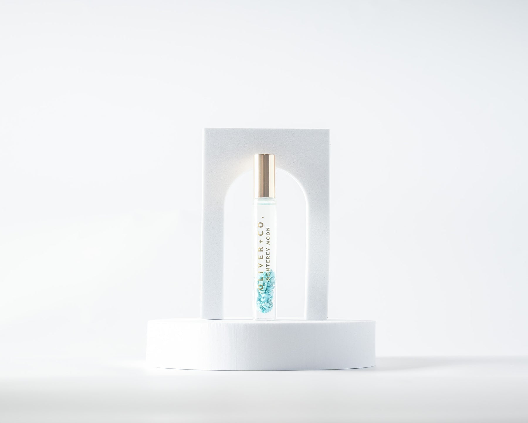 Oliver + Co. Monterey Moon Bougie Stick perfume oil with blue crystals in a glass roll-on bottle.