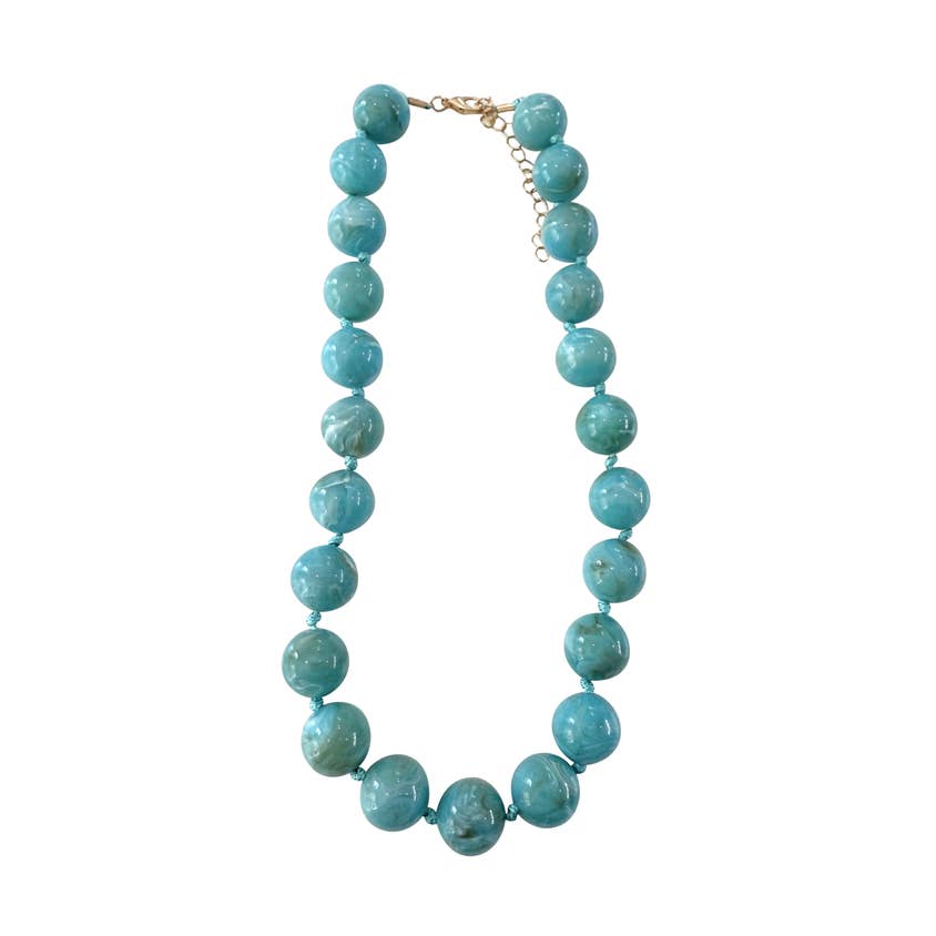 Mabry Chunky Beaded Necklace featuring large, glossy marbled turquoise beads with a gold clasp.