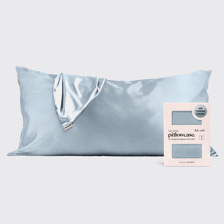 Light blue satin pillowcase shown next to its product packaging.