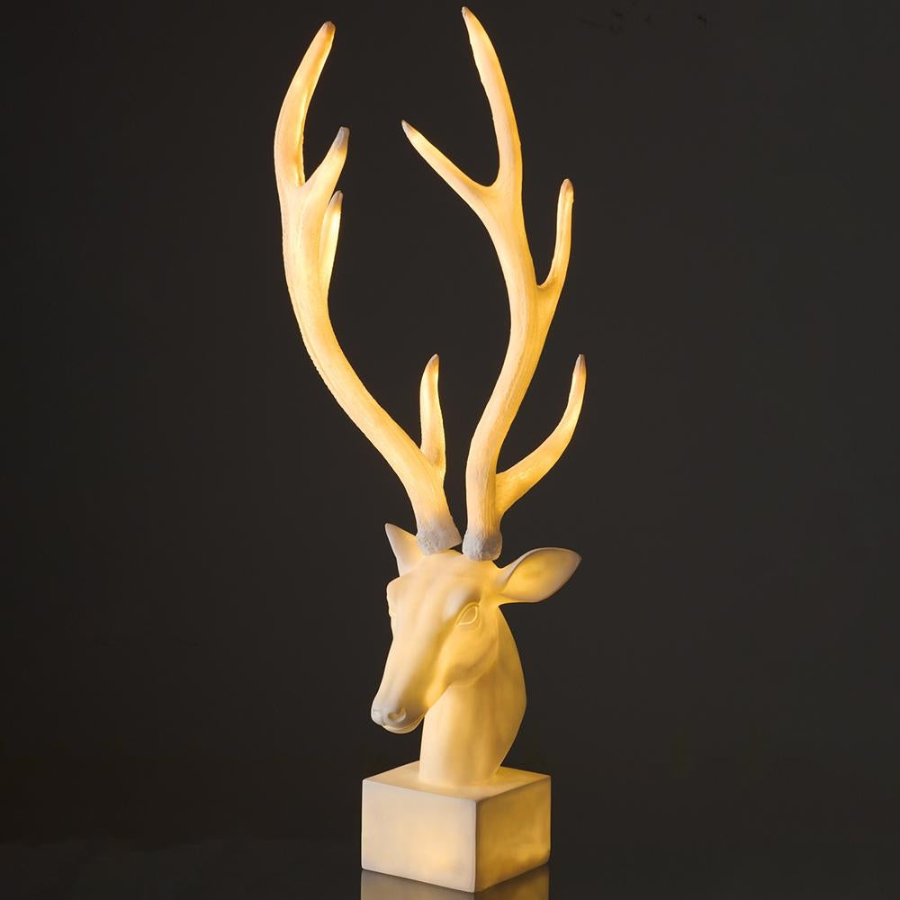 37.5 inch antique white lighted reindeer tabletop statue with large antlers on a square base.