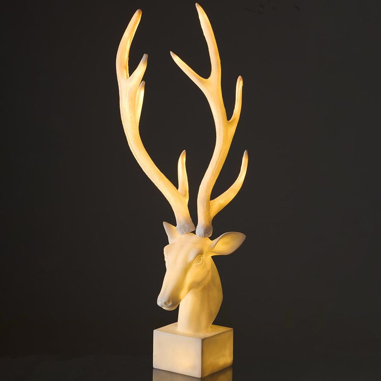 37.5 inch antique white lighted reindeer tabletop statue with large antlers on a square base.