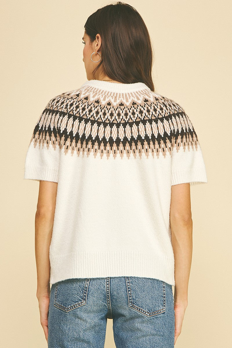 Back view of a white short-sleeve knit cardigan with a black and tan Nordic fair isle pattern.