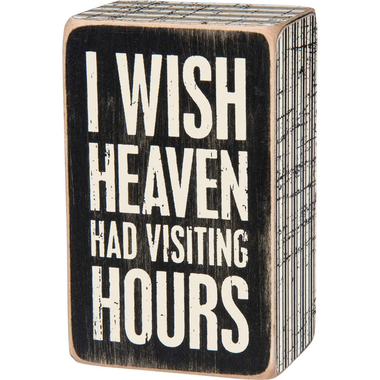 Wooden box sign with black background and white text reading 'I WISH HEAVEN HAD VISITING HOURS'.