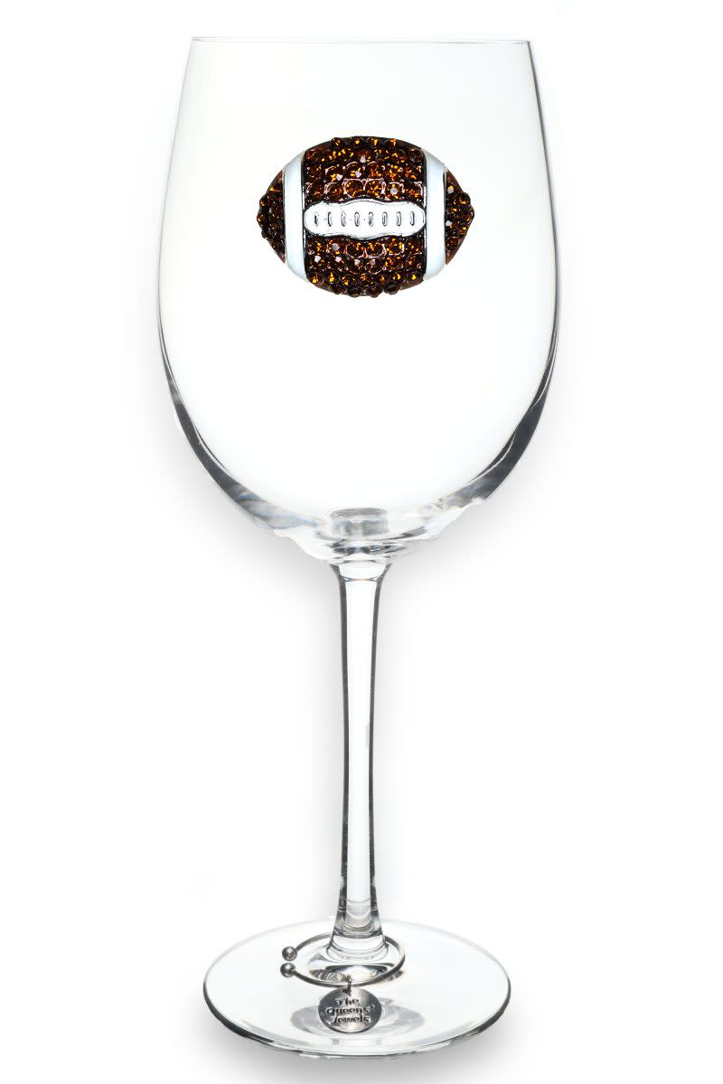 Stemmed wine glass featuring a brown jeweled football emblem and a silver charm on the base.