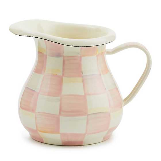 Hand-painted rosy pink and cream checkered enamelware creamer with a handle and spout.