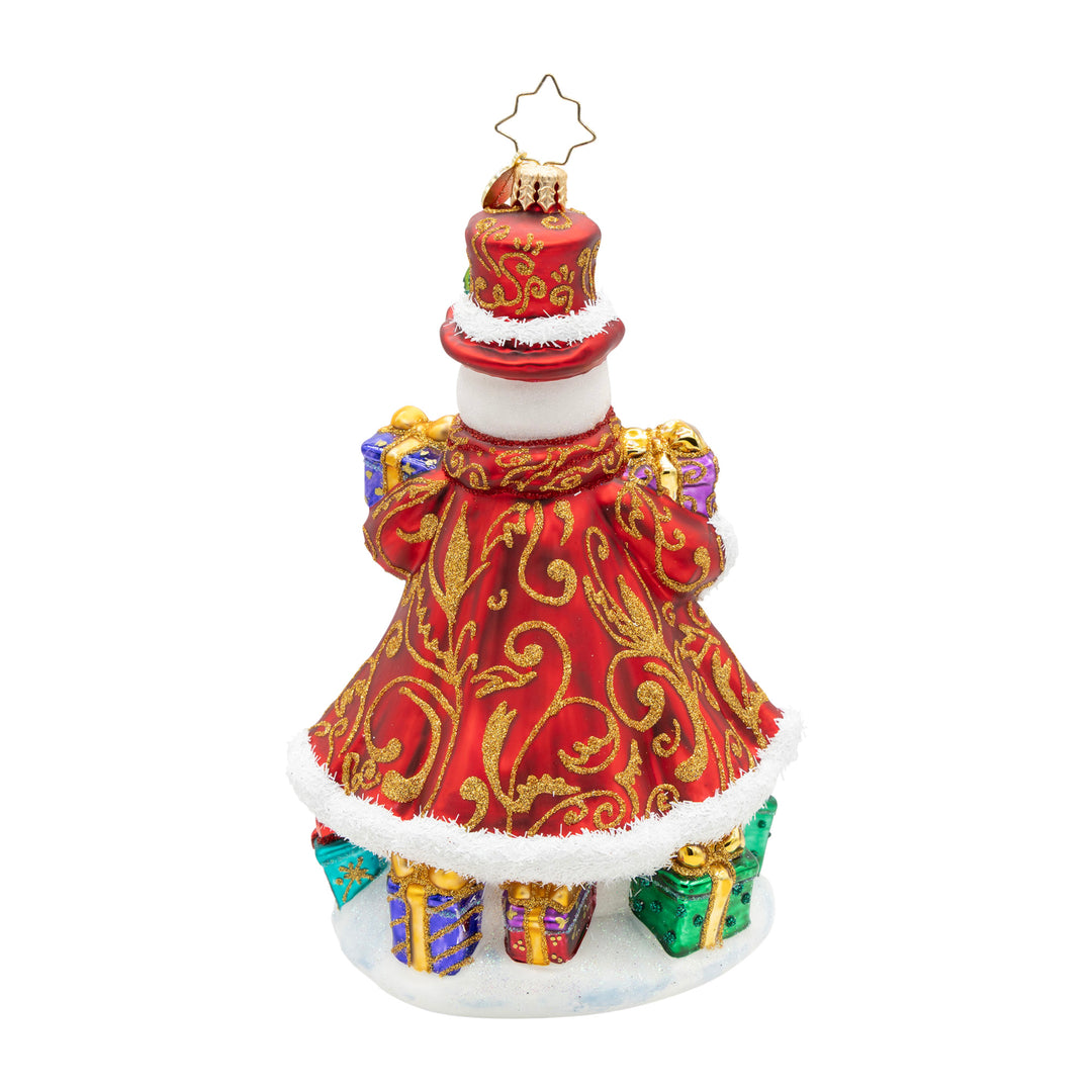 Back view of a snowman ornament in a red gold-swirled coat holding colorful gifts.