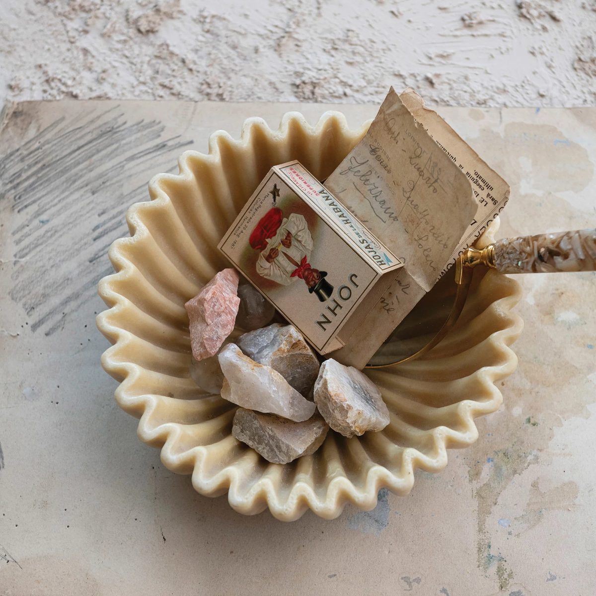 Round decorative resin pleated bowl in neutral tone with textured ruffled edges.