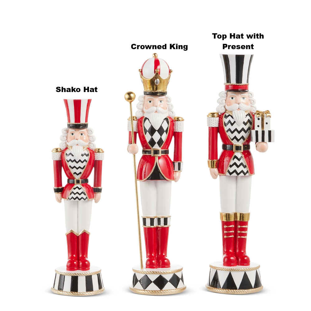 Three red, white, and black resin nutcrackers: Shako Hat, Crowned King, and Top Hat with Present.