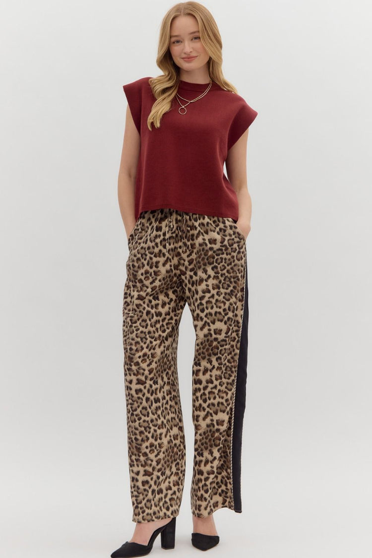 Woman wearing a burgundy Olivia Solid Crewneck Sweater Knit Muscle Tee Top with leopard print pants.