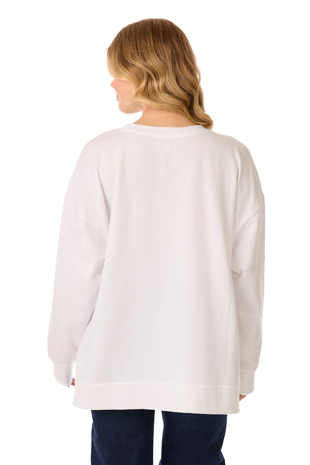 Back view of a woman wearing a plain white oversized sweatshirt and dark blue jeans.