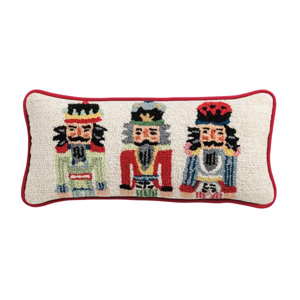 Two hooked wool nutcracker pillows in red with black hats and white beards on a neutral background.