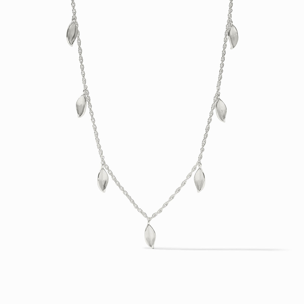Silver Willow Delicate Charm Necklace featuring seven small leaf-shaped pendants on a fine chain.