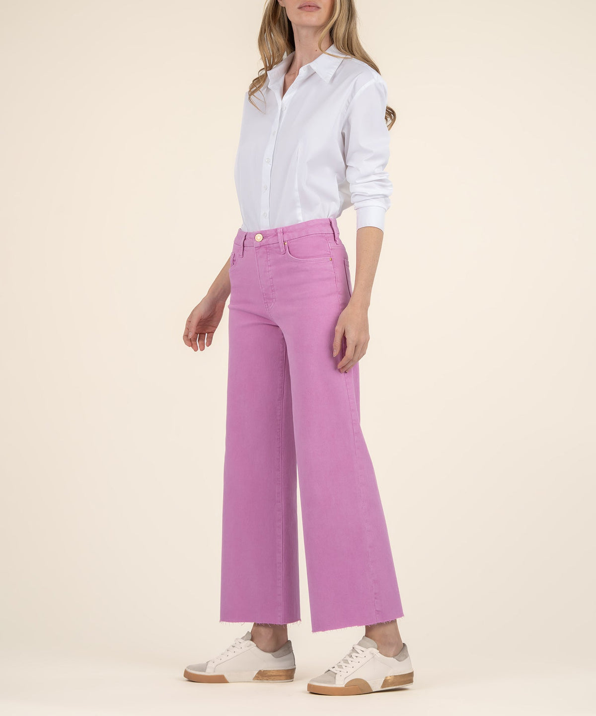Woman wearing Meg High Rise Fab Ab Wide Leg jeans in pink with a white button-down shirt.