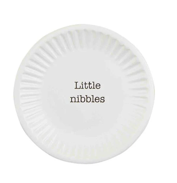 Small white round ceramic tapas plate with fluted edges and the text 'Little nibbles' in the center.