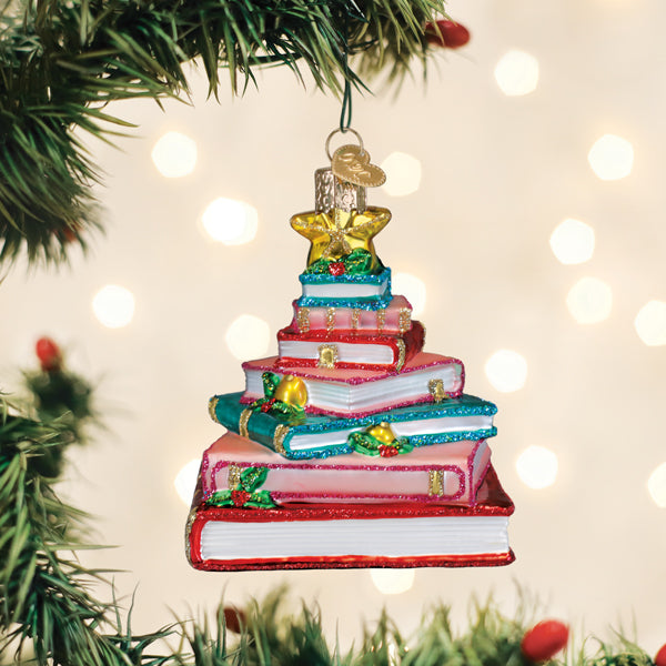 Red ceramic tree ornament shaped like a book with visible spine text.