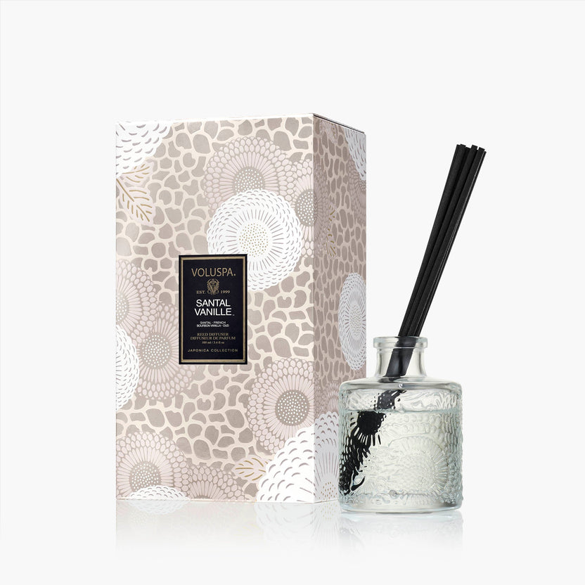Santal Vanille candle in a clear glass jar with natural wick