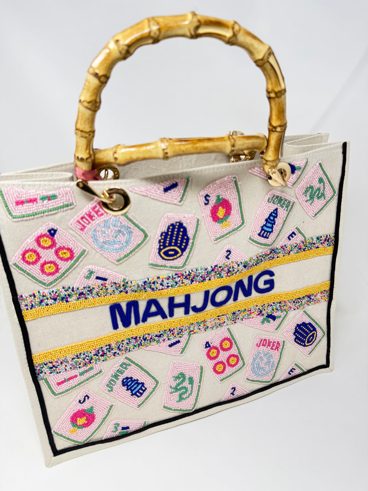 Hand-beaded Mahjong tote bag with bamboo handles, pink tile designs, and blue beaded lettering.