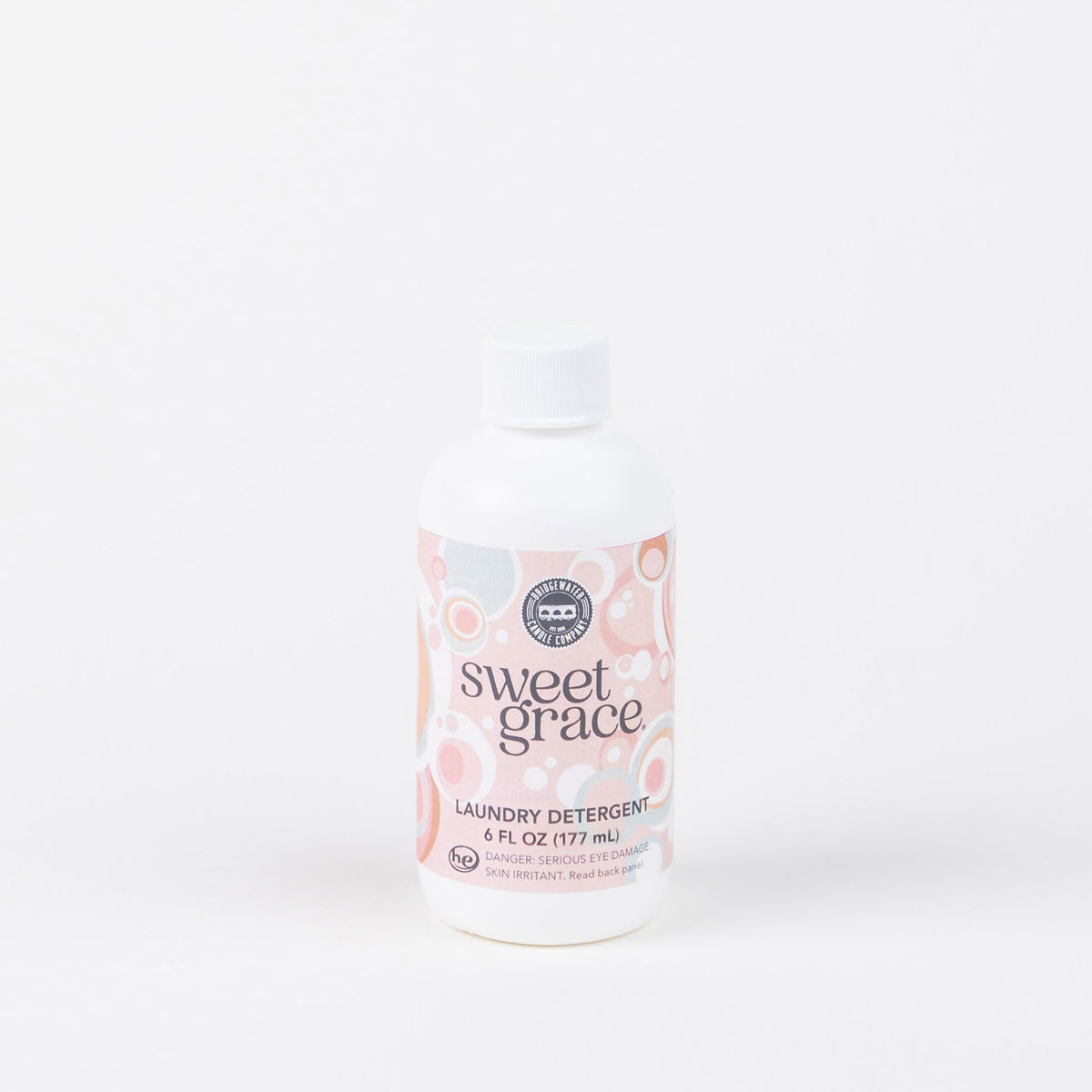 Sweet Grace 6oz Laundry Detergent in a white bottle with a pink and white patterned label.