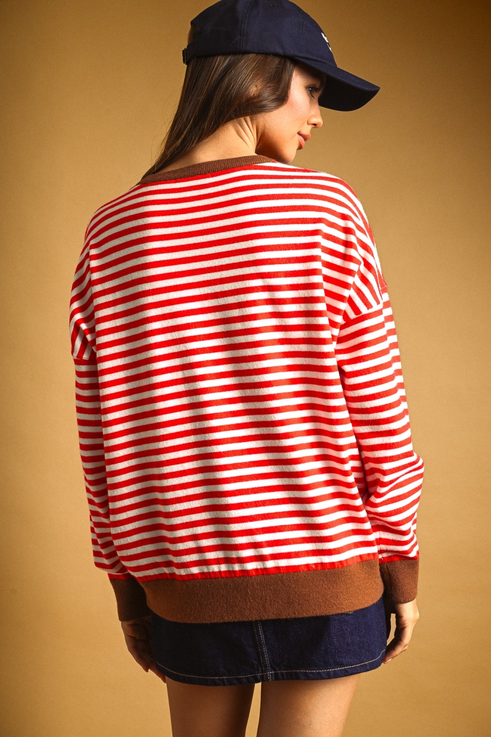 Back view of a woman wearing the red and white striped Alessia knit top with brown ribbed trim.