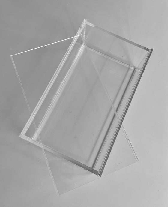 Clear acrylic mahjong box with a sliding lid shown partially open on a grey background.