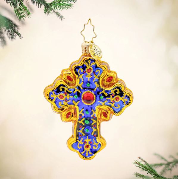 Sacred Season Cross Gem glass ornament with blue center, gold trim, and red and green accents.
