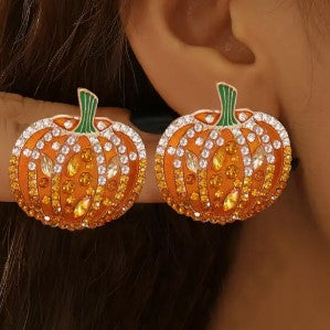 Gold-tone pumpkin shaped earrings featuring clear rhinestone accents.