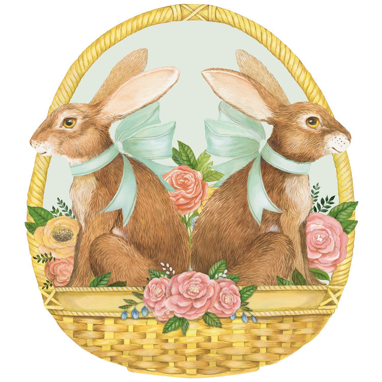 Die-cut oval paper placemat featuring two brown bunnies with blue bows in a floral basket.