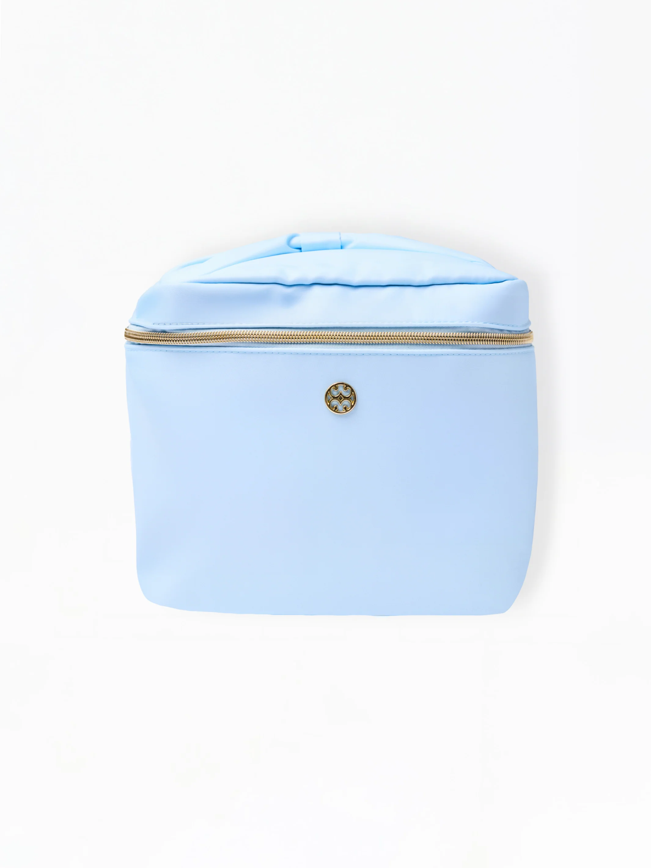 Sky blue nylon makeup bag with a gold zipper and circular logo emblem.