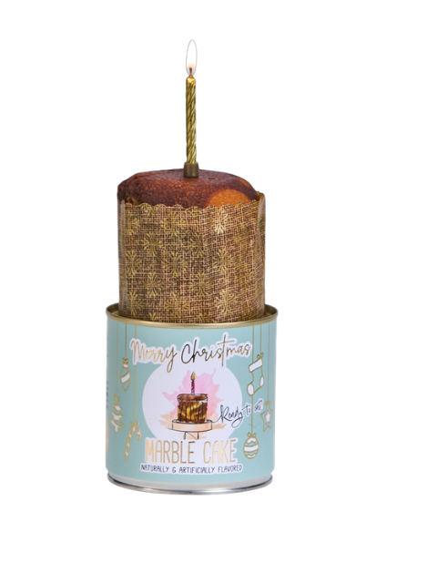 Marble Cancake in a light blue tin with a lit gold candle on top for Christmas.