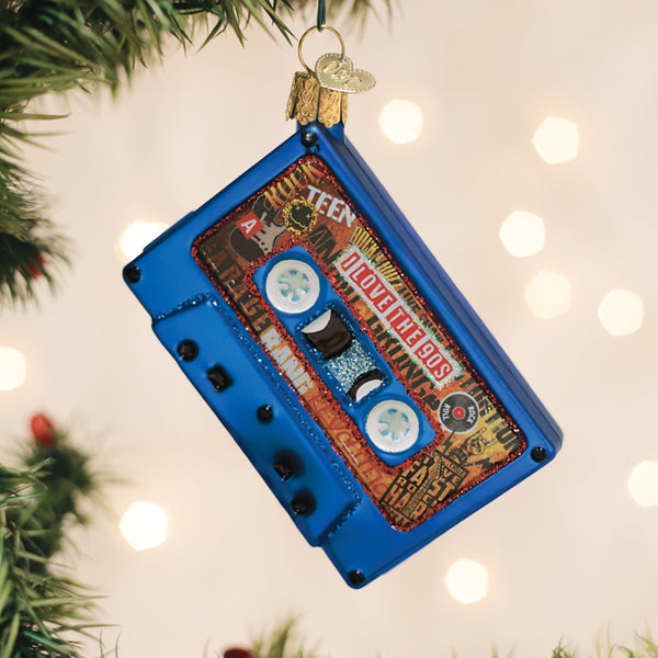 Blue cassette tape Christmas ornament with 'I Love the 90s' text and retro collage design.