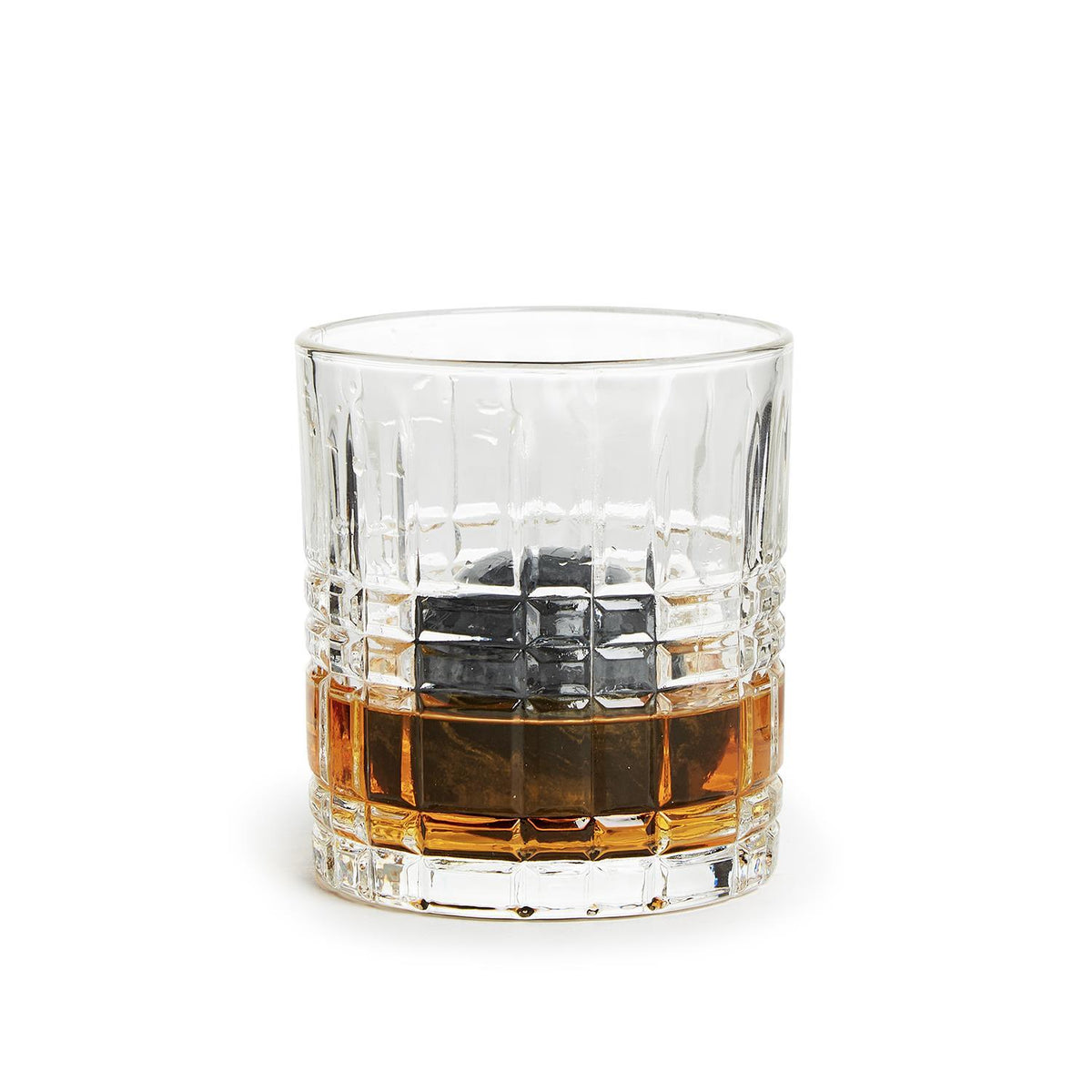 Double Old Fashioned glass with amber whisky and a dark marble stone ball chiller inside.