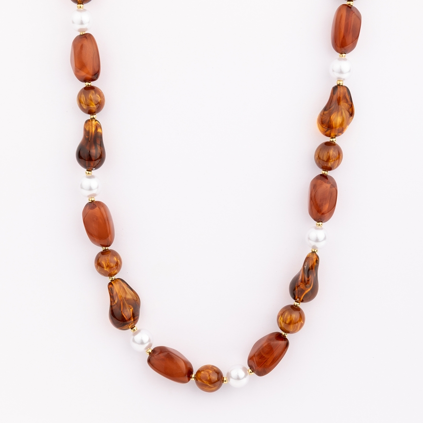 Zoe Necklace featuring chunky amber-colored resin beads and white pearls on a gold-plated chain.