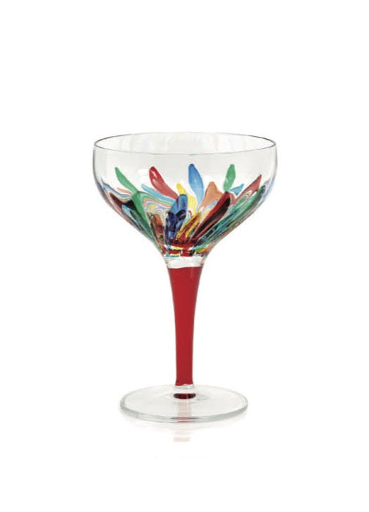 Clear coupe glass with a red stem and colorful abstract floral pattern.