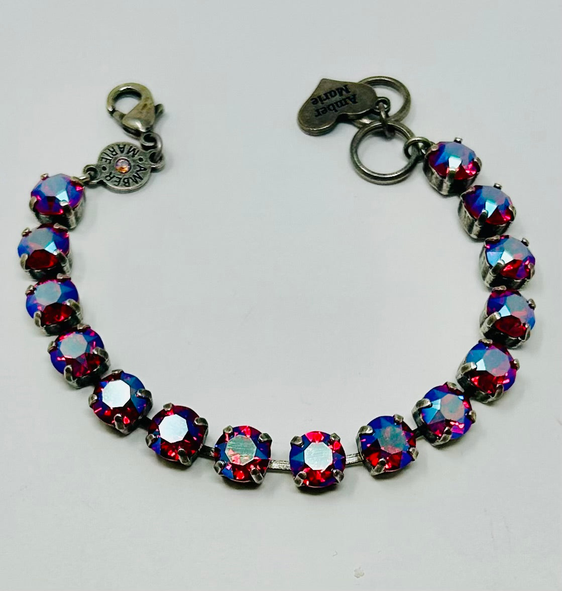 Classic Vienna bracelet featuring a delicate chain link with an ornate central charm in antique gold finish.