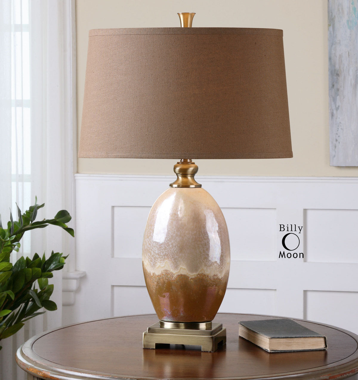 Eadric ceramic table lamp with a neutral beige finish and simple cylindrical silhouette.