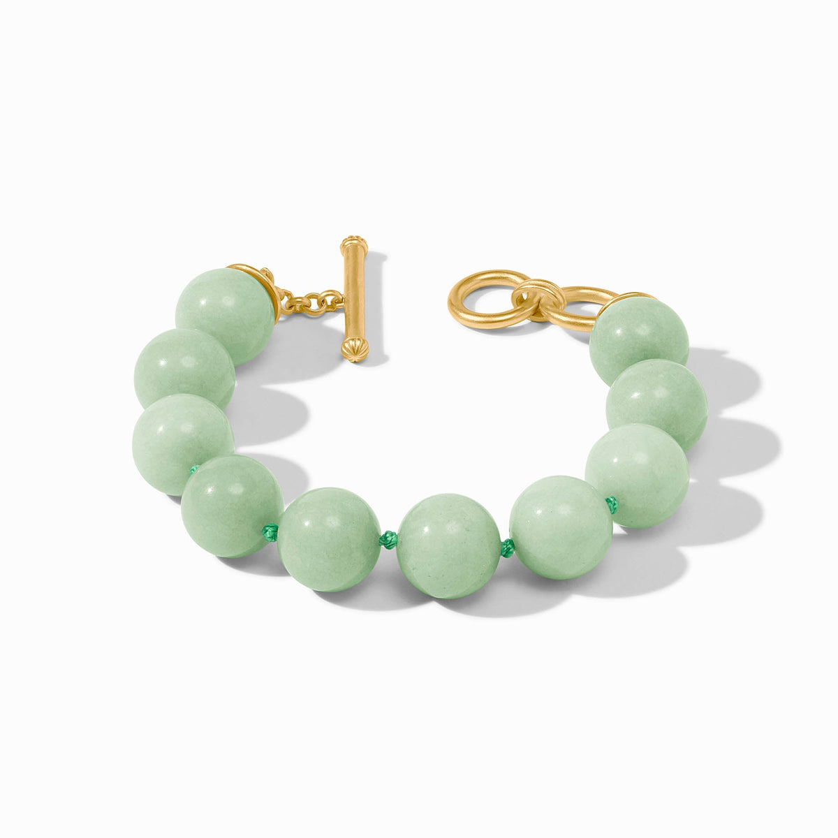 Polished beaded bracelet with jade accents in gold plate featuring a toggle clasp.