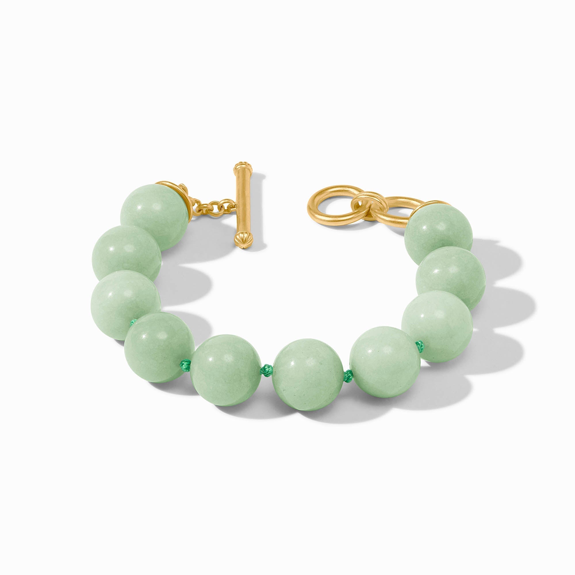 Polished beaded bracelet with jade accents in gold plate featuring a toggle clasp.